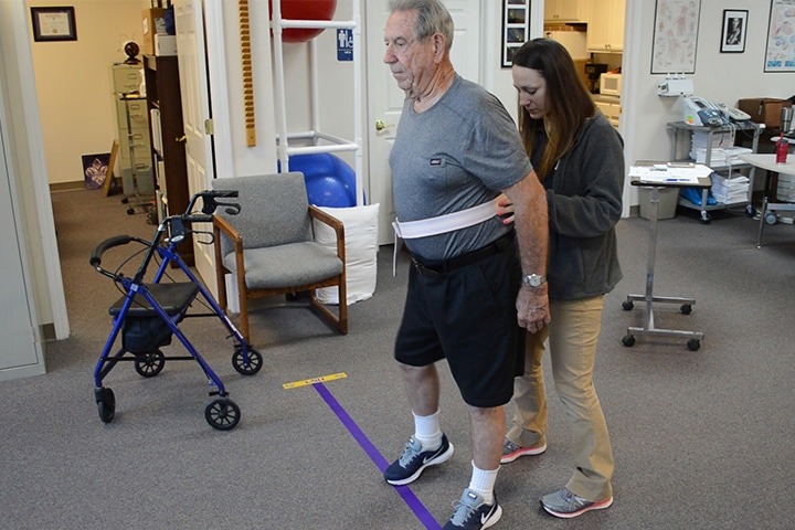 NMC physical therapist helping patient walk