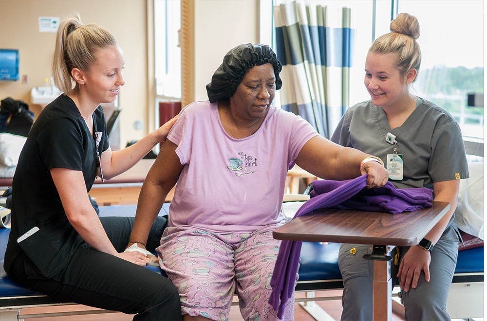 Photo of NMC therapists helping Inpatient