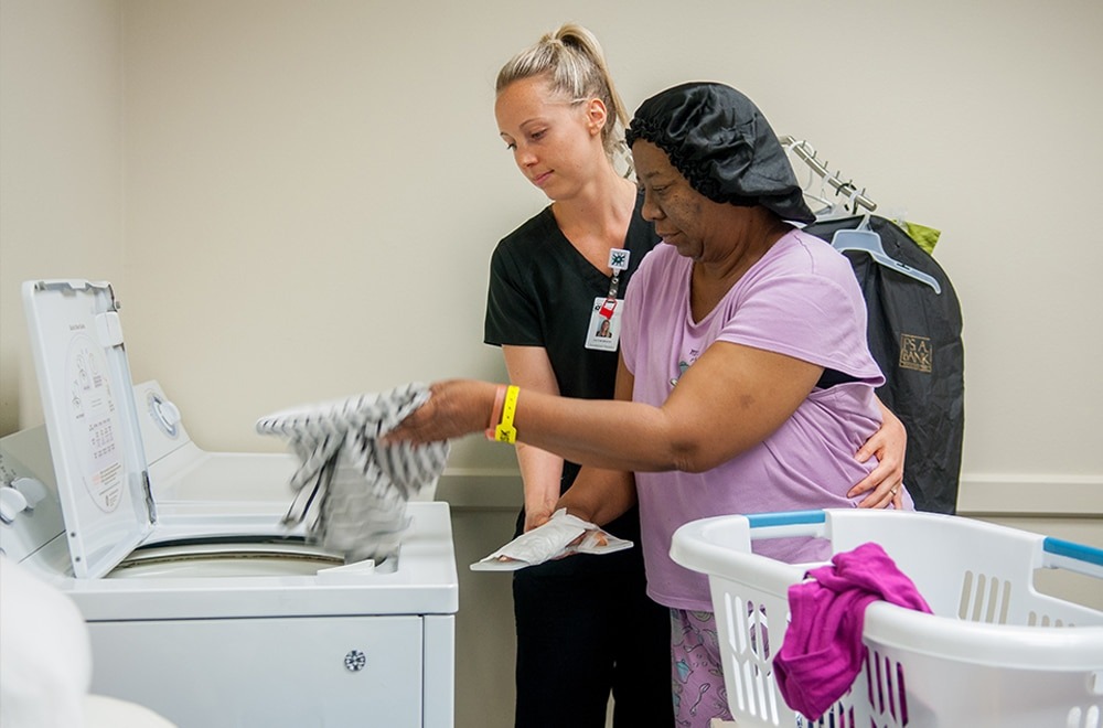 Rehab Nurse at The NeuroMedical Center Helping Patient with ADLs