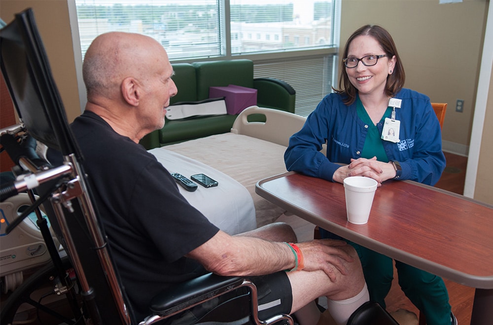 Rehab Nurse Visiting With Patient